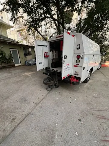 Magnet Plumbing service vehicle on-site for Grease Trap Cleaning in Tyndall Village